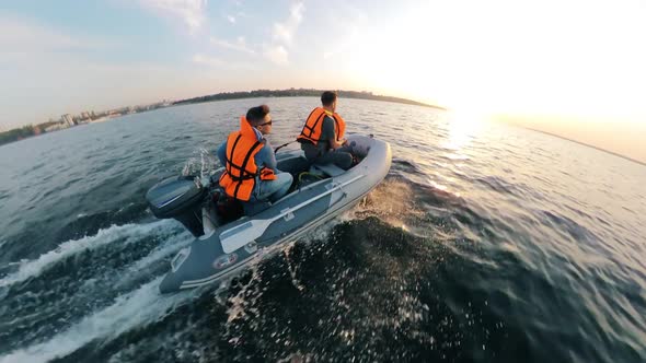 Men in Lifevests Are Navigating the Inflatable Boat