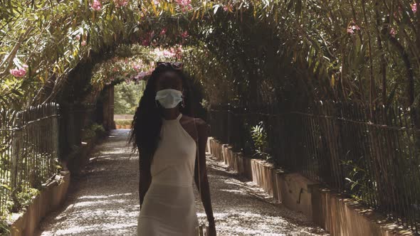 Facemask Wearing Tourist In White At The Alhambra