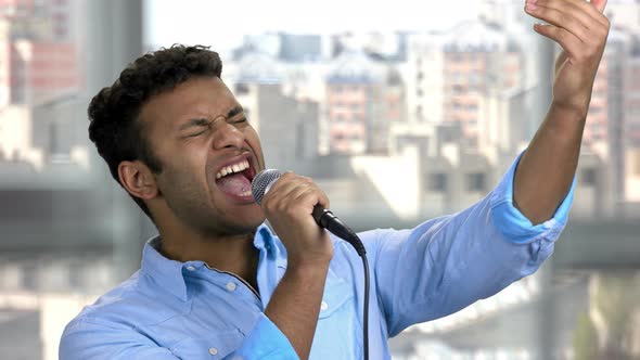 Young Indian Singer Performing with Microphone