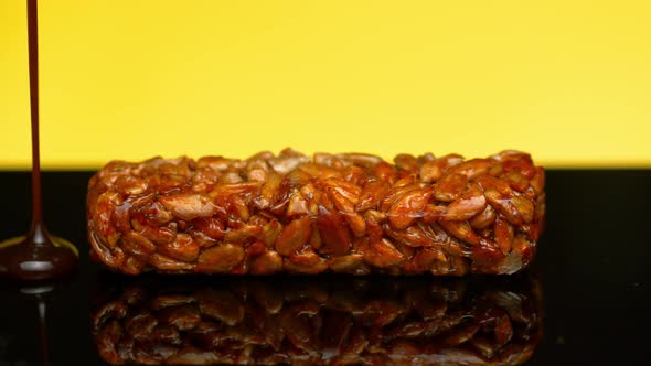 Food Footage Dark Chocolate Pour on Sunflower Seeds in Caramel