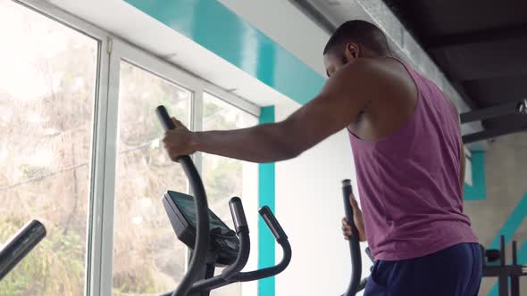 Black Man Workout on Crosstrainer in the Gym