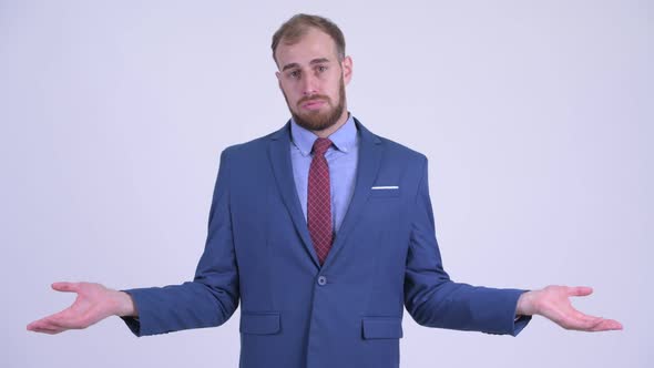 Confused Bearded Businessman Shrugging Shoulders