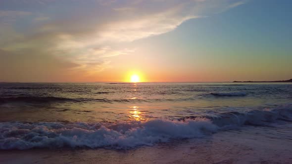 Sunset beach landscape. Summer altantic ocean coast. Waves and orange sky