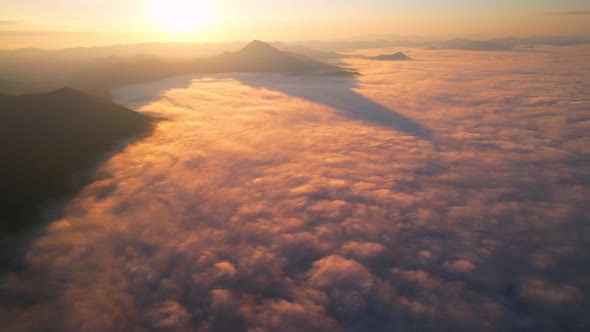 4K Aerial video Beautiful sunrise above dense clouds and fog in the morning