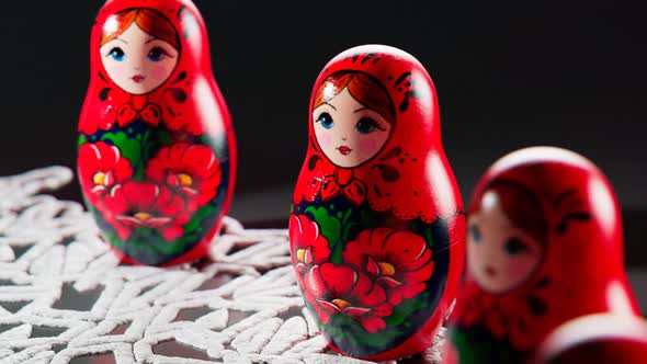 Matryoshka dolls placed in a circle. A camera follows one babushka after another