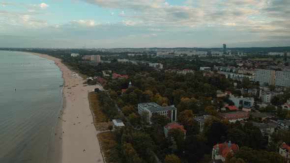 Cityscape of holiday resort city. Hotels and buildings with beachfront. Aerial