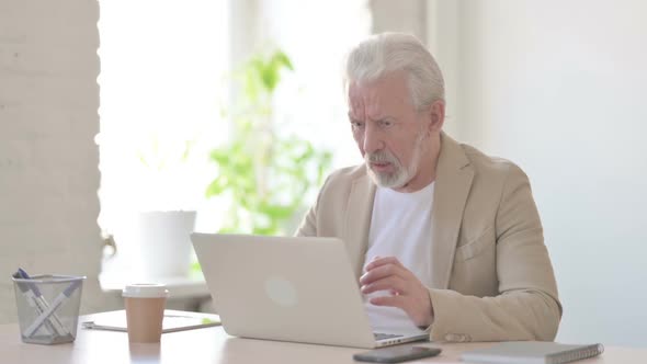 Old Man Reacting to Loss While Using Laptop