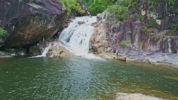 Drone View Azure Lake with Waterfall and Creek Among Rocks