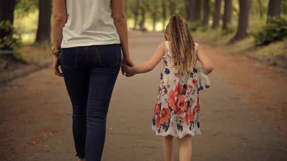 Little Girl Holding Mother Hand. Cute Adorable Kid Enjoy Together With Family.Pretty Child Daughter.