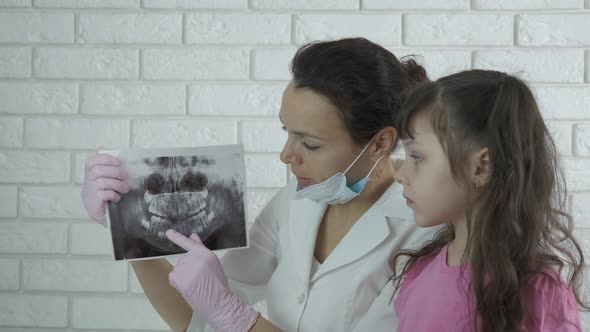 Doctor with a dental picture. 