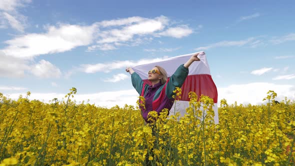 Woman with Belarus flag in yellow rapeseed field