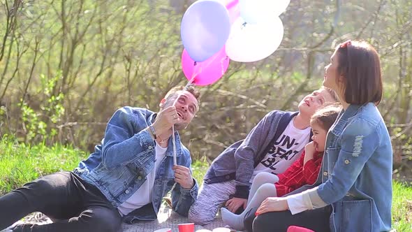 happy family around the campfire, picnic