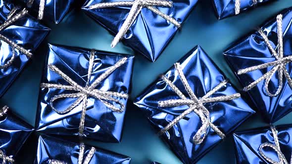 Blue Gift Boxes on Blue Color Background. Christmas and New Year Rotating Backdrop. Present