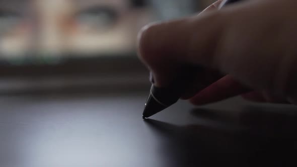 SLOW MOTION: Close Up of a digital pen on graphic tablet with painting