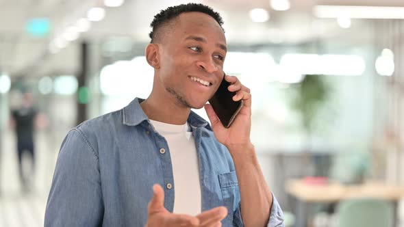 Portrait of Cheerful Casual African Man Talking on Smartphone