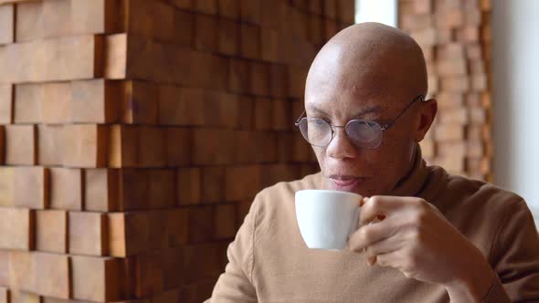 An African American Man Drinks Coffee