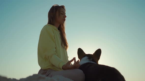 Pretty Confident Woman Doing Yoga and Meditation Practicing at Sunrise on Beach