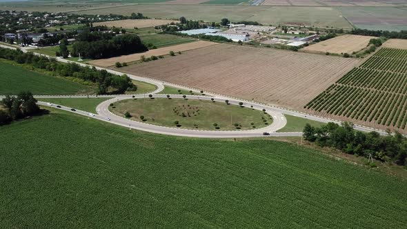 Aerial View of Empty Highway Road Circle Between Meadow and Agricultural Field