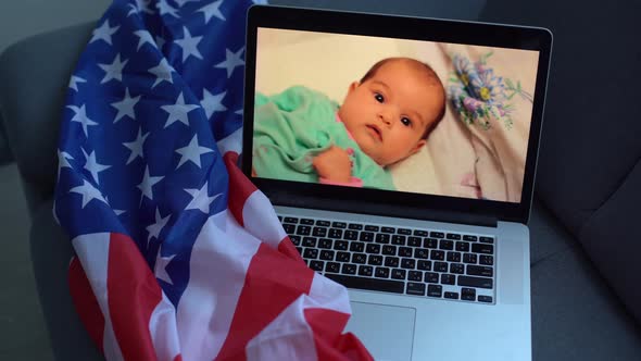 Video with a Toddler on a Laptop Next to the Usa Flag