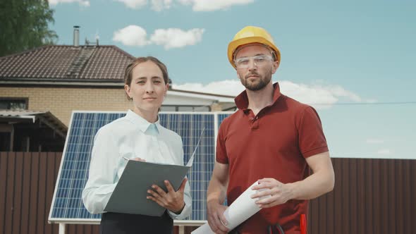 Portrait of Workers Posing Before Solar Panels