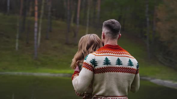 Lovely couple outdoors. Romantic couple in warm sweaters enjoying spending time together. 