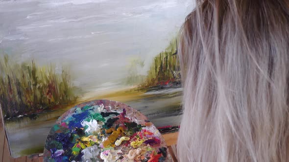 Blond Artist Paints Oil Paints on Canvas. Details, Front View