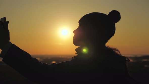 Silhouette of a Woman in Sunshine, Selfie, Taking Pictures at Sunset, Sunrise. Free Young Girl