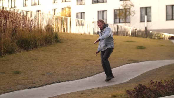 A Carefree Guy Dancing Down the Road