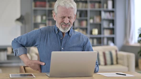 Tired Old Man Having Back Pain in Office