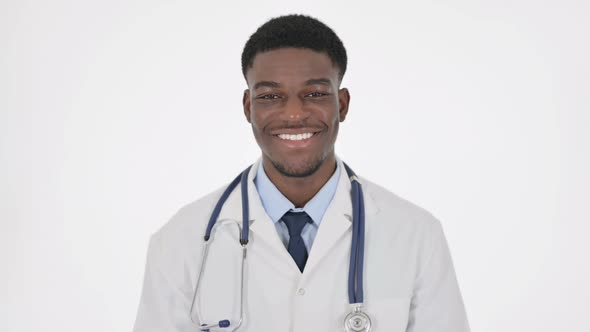 African Doctor Smiling at Camera on White Background