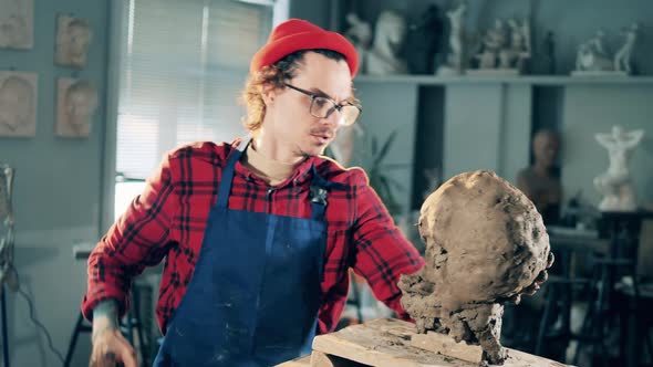 Angry Sculptor is Destroying a Clay Head