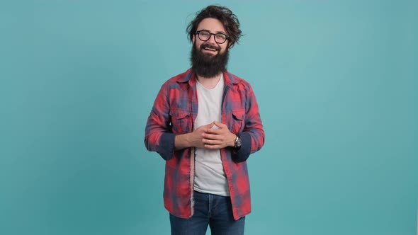 Portrait of Bearded Handsome Young Man That Is Smiling Over Turquoise Background