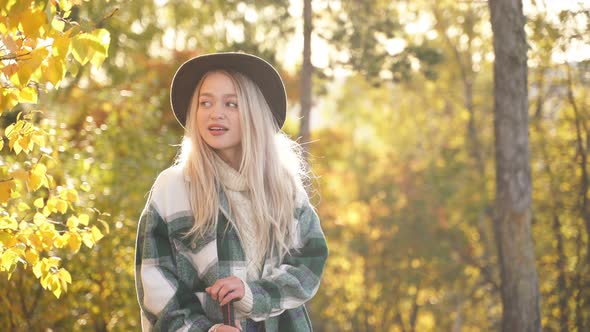 Happy Caucasian Blonde Woman Is Enjoying Time in the Forest