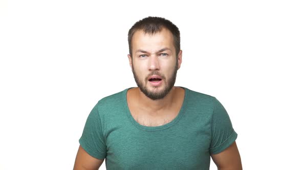 Slowmotion Horizontal Portrait of Handsome Displeased Guy with Short Brown Hair Being Surprised