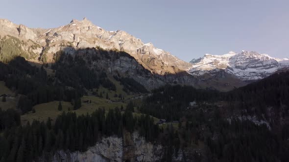 Aerial shot of high mountains peaks at the end of the day