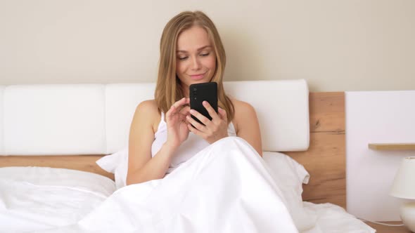 Woman Using Smartphone After Waking Up.