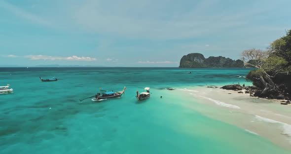 Turquoise Sea with Boats Moored at Shore Aerial