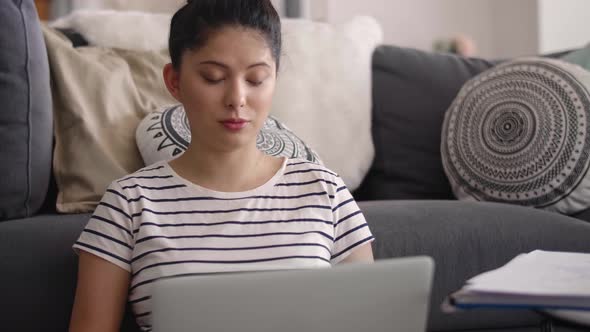 Young Asian woman talking with someone during a video conference 