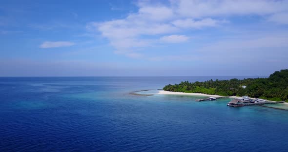 Beautiful aerial abstract shot of a sunshine white sandy paradise beach and blue ocean background in