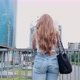 From behind young woman looking city panorama dreamlike - VideoHive Item for Sale