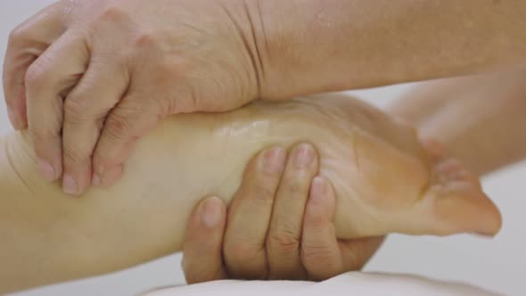 Close-up in Slow Motion of a Foot Being Massaged at Spa