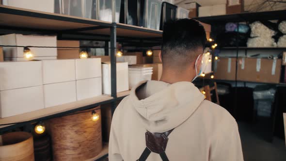 Asian Korean Man Worker Wearing Protective Face Mask and Check Stock in Warehouse