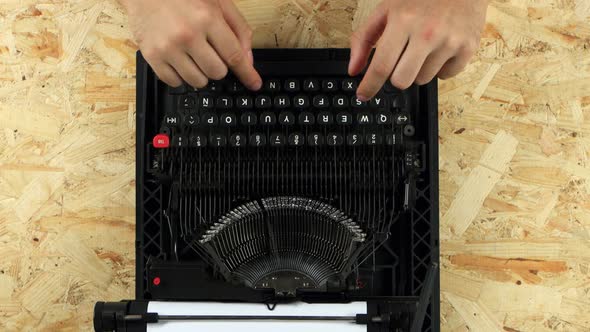 Guy Is Typing on a Printed Retro Typewriter. View From Above