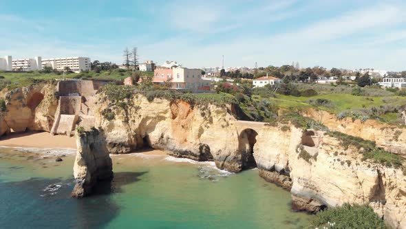 Idyllic Estudante Beach ocean front with Roman bridge near coastline, Algarve, Portugal