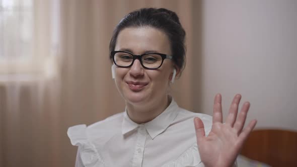 Smiling Woman Waving Goodbye in Video Chat Throwing Away Paperwork Leaving