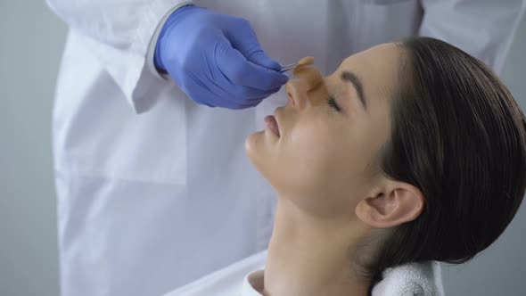 Woman Satisfied With Rhinoplasty Result, Cute Smiling Face Reflected in Mirror