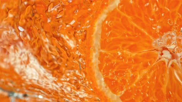 Super Slow Motion Shot of Splashing Water From Rotating Tangerine Slice at 1000Fps.