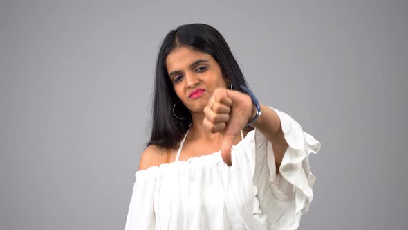 Indian girl showing thumbs down