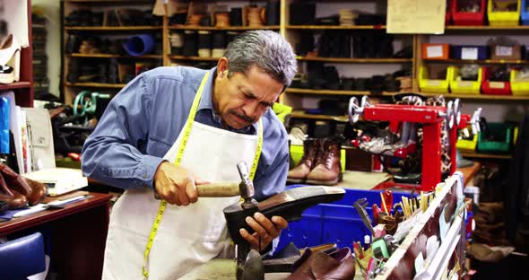 Cobbler making shoes with a hammer