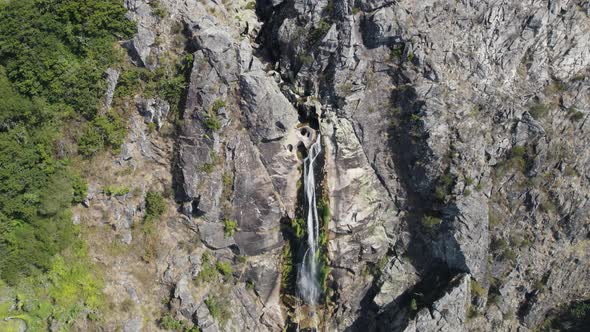 Aerial zoom in of natural waterfall named "Frecha da Mizarela" at Serra da Freita. Arouca geopark